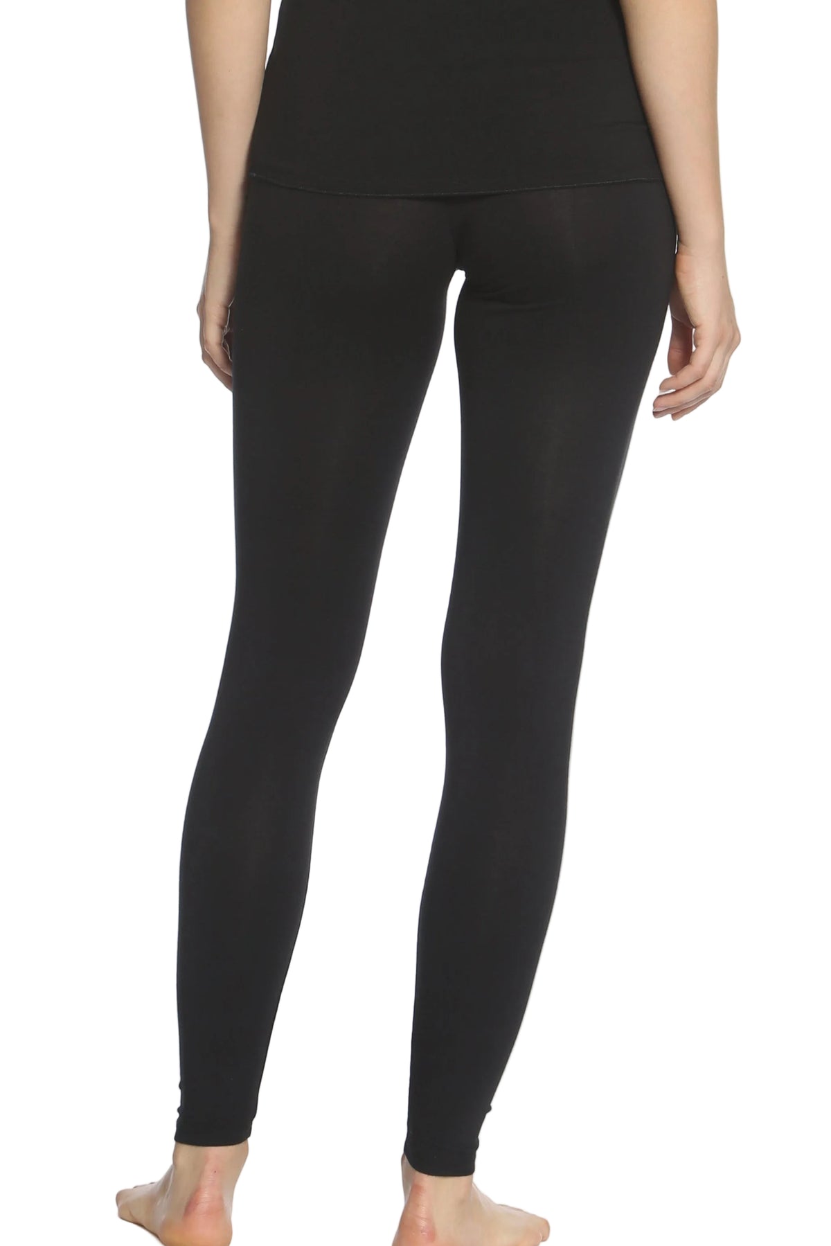 Back view of woman wearing black cotton loungewear leggings, barefoot, on white background