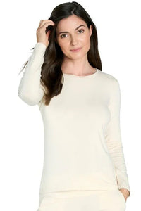 Woman wearing long sleeve almond color Pima cotton loungewear top, relaxed fit