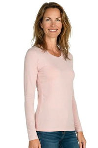 Woman wearing light pink long sleeve Pima cotton loungewear top and blue jeans