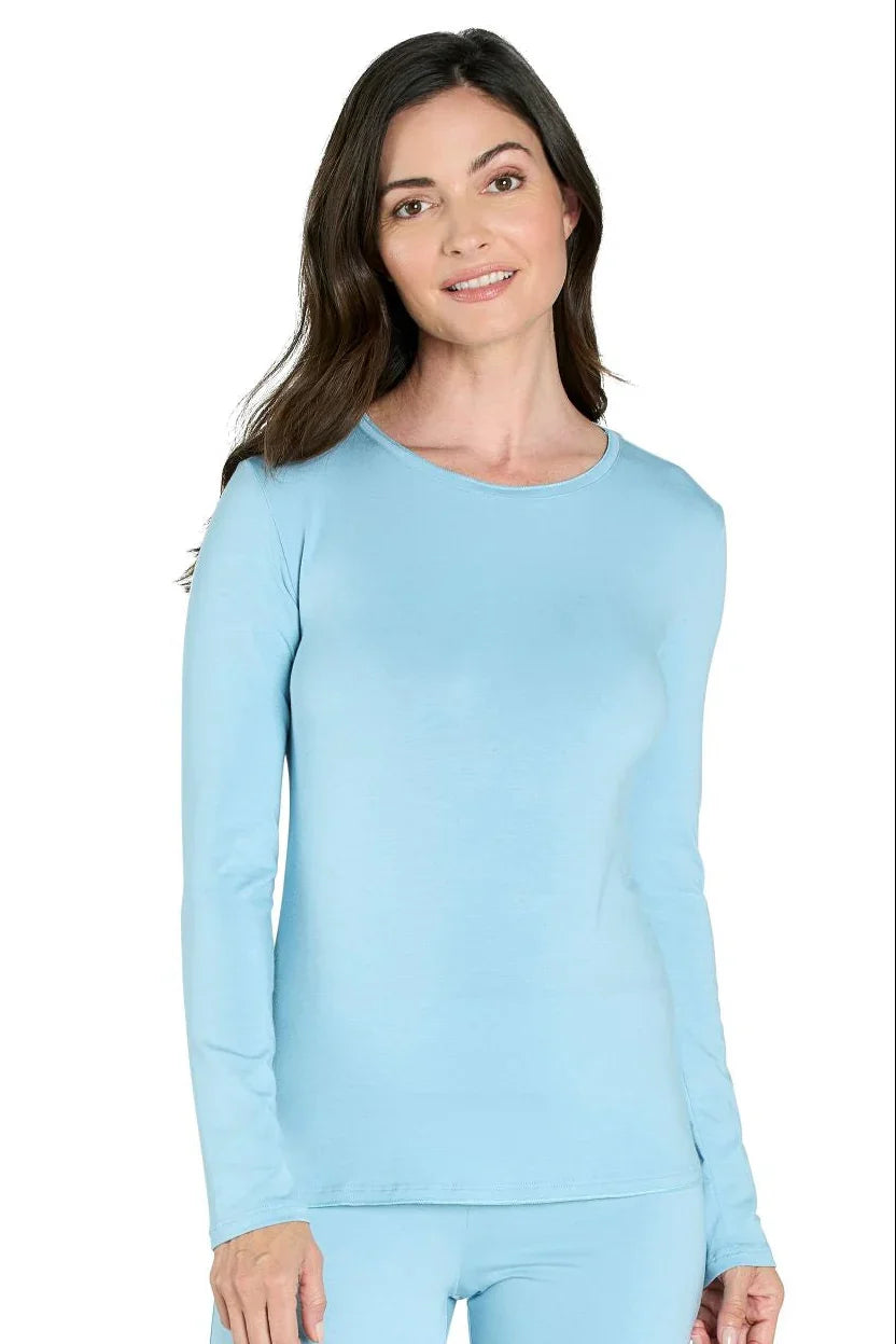 Woman wearing sky blue long sleeve Pima cotton loungewear top, white background