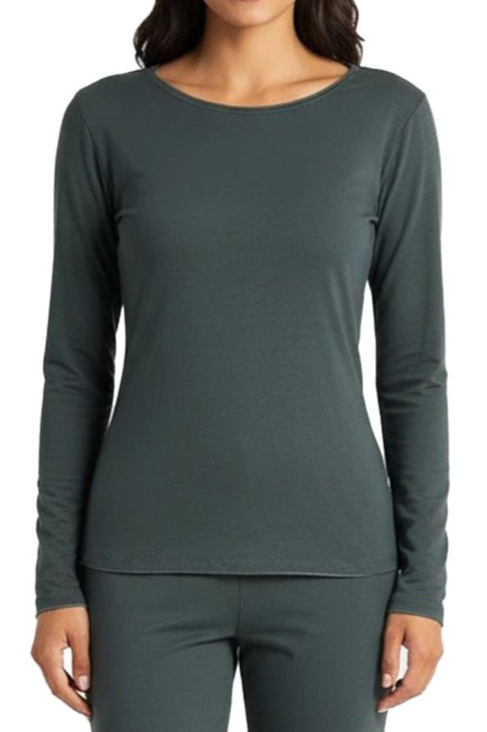 Person wearing a dark green long-sleeve top and pants on a white background