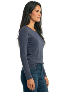 Woman wearing a steel blue long sleeve Pima cotton loungewear top and blue jeans