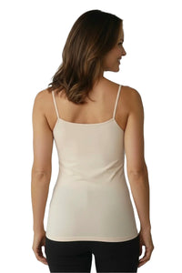 Woman wearing a light beige camisole top with thin straps, back view against white background