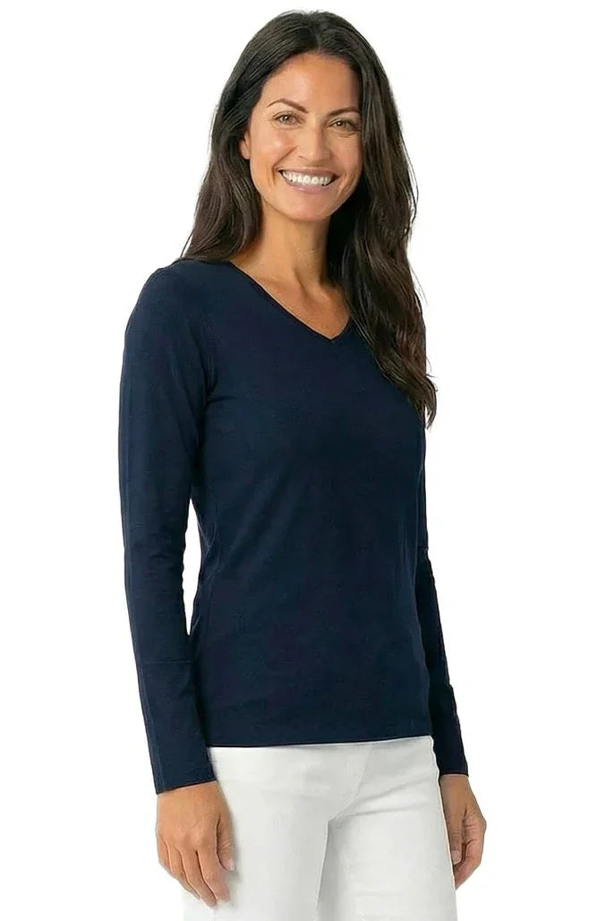 Woman wearing a long sleeve black Pima cotton loungewear tee and white pants