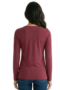 Woman wearing a burgundy long sleeve cotton loungewear top and blue jeans, back view