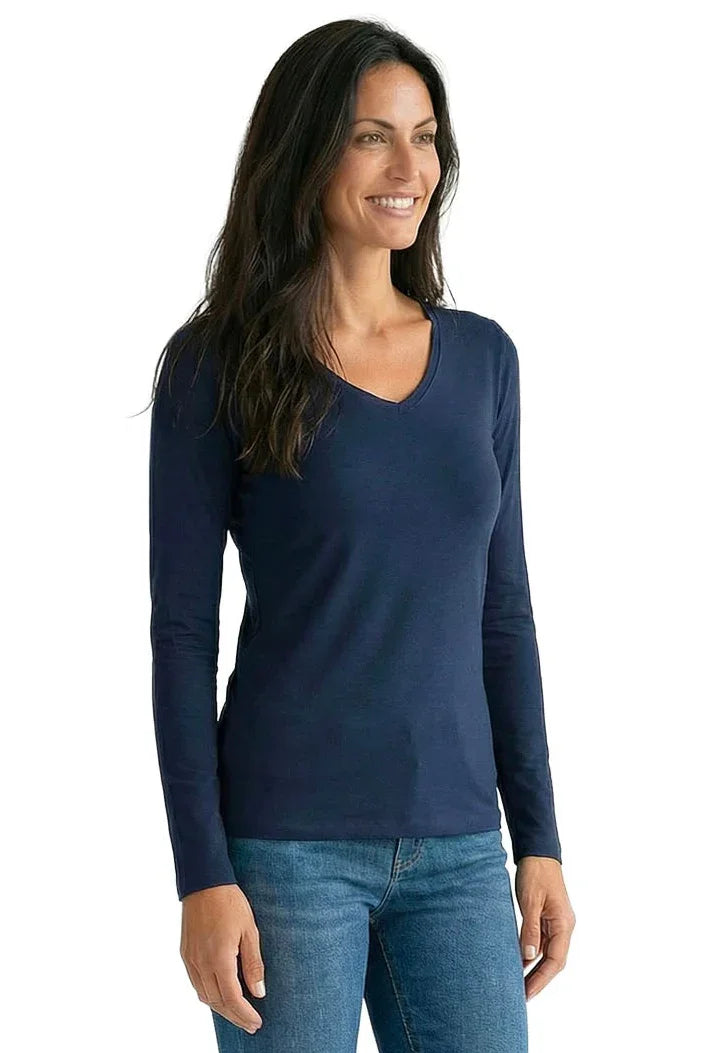 Woman wearing a midnight blue long sleeve V-neck Pima cotton tee and blue jeans