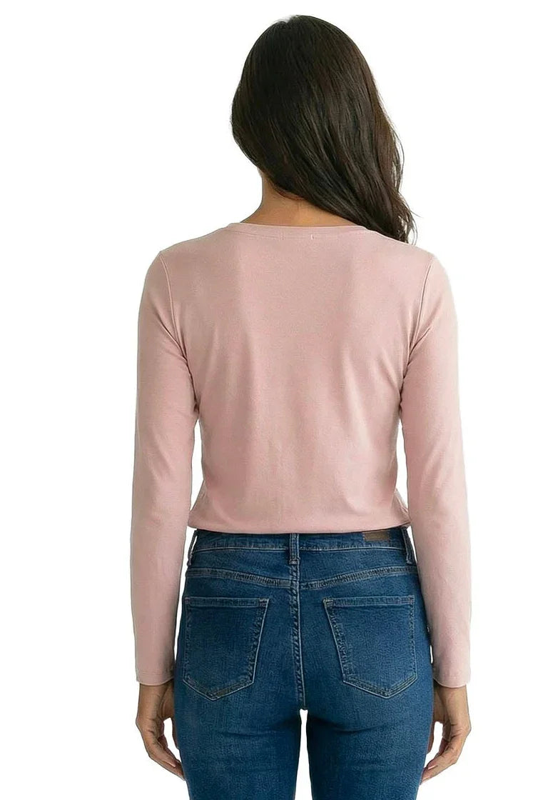 Woman wearing a light pink long sleeve Pima cotton tee and blue jeans, rear view