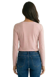 Woman wearing a light pink long sleeve Pima cotton tee and blue jeans, rear view