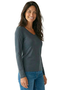 Woman wearing steel blue long sleeve Pima cotton loungewear top and blue jeans