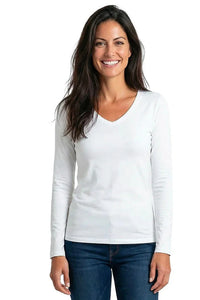 Woman wearing a white long sleeve V-neck Pima cotton tee and blue jeans, smiling