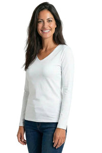 Woman wearing a white Pima cotton long sleeve v-neck lounge top and jeans