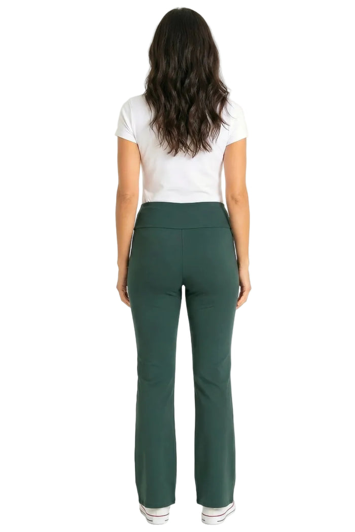 Woman in white short sleeve tee and green lounge pants, standing, back view, on white background