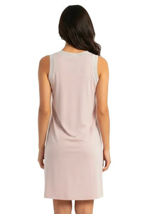 Back view of woman in sleeveless shell pink loungewear nightdress with lace trim