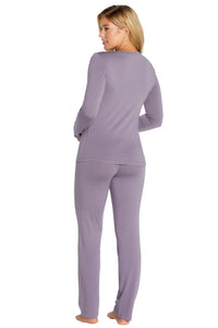 Woman wearing a lavender pajama set on a white background
