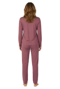 Woman wearing rosewood pink long-sleeve loungewear pajama set, viewed from back