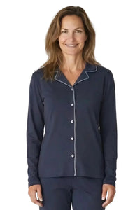 Woman wearing navy blue Pima cotton long sleeve button-up pajama top with contrast piping