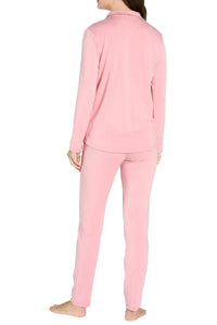 Woman wearing pink long sleeve loungewear set with pants, shown from the back