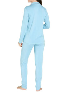 Woman wearing sky blue long sleeve loungewear pajamas, shown from the back