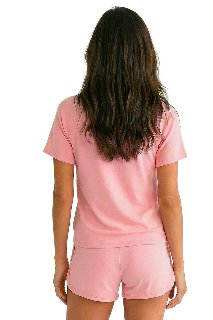Woman in soft pink Pima cotton loungewear sleep set, viewed from the back on white background