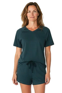 Woman wearing dark green short sleeve Pima cotton lounge set with drawstring shorts