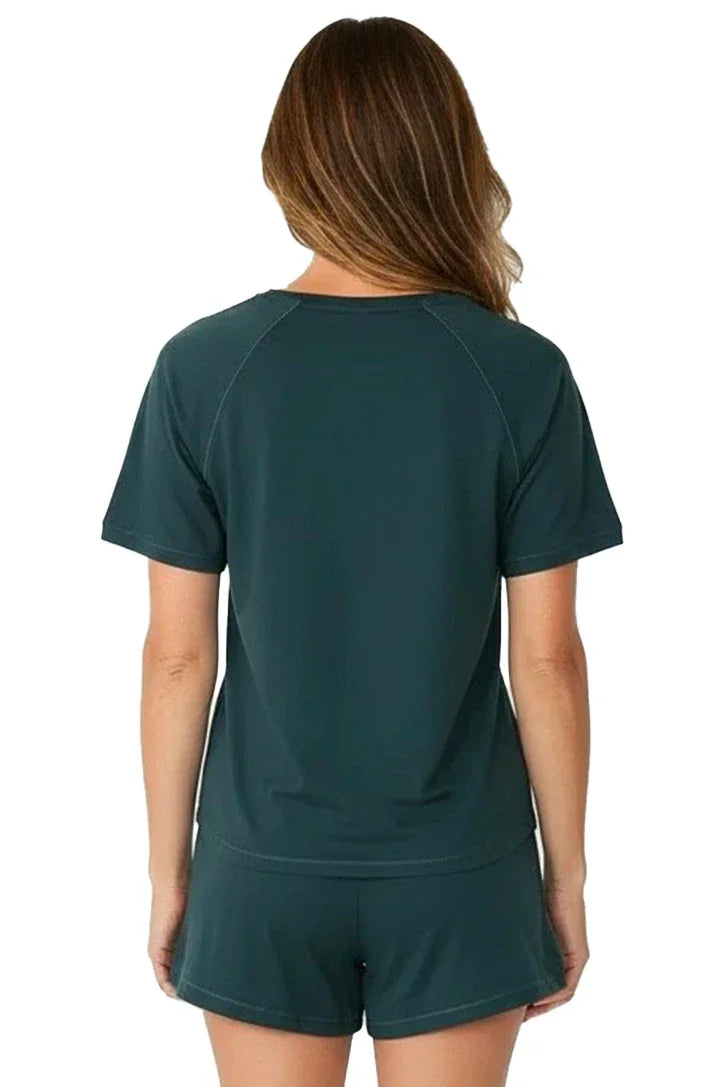 Woman wearing dark green Pima cotton loungewear sleepwear tee and shorts, back view