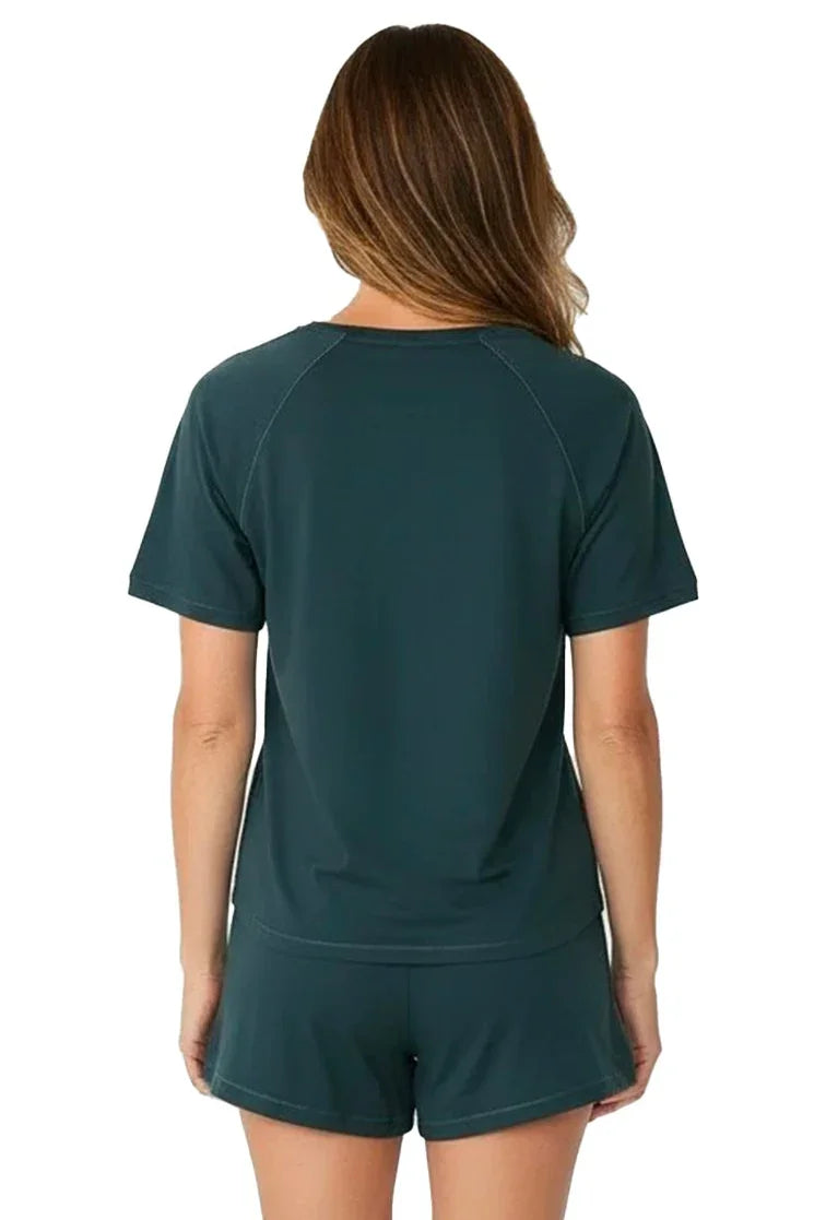 Woman wearing dark green Pima cotton loungewear short-sleeve top and shorts set, back view