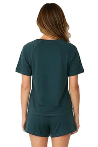 Woman wearing dark green Pima cotton loungewear short-sleeve top and shorts set, back view