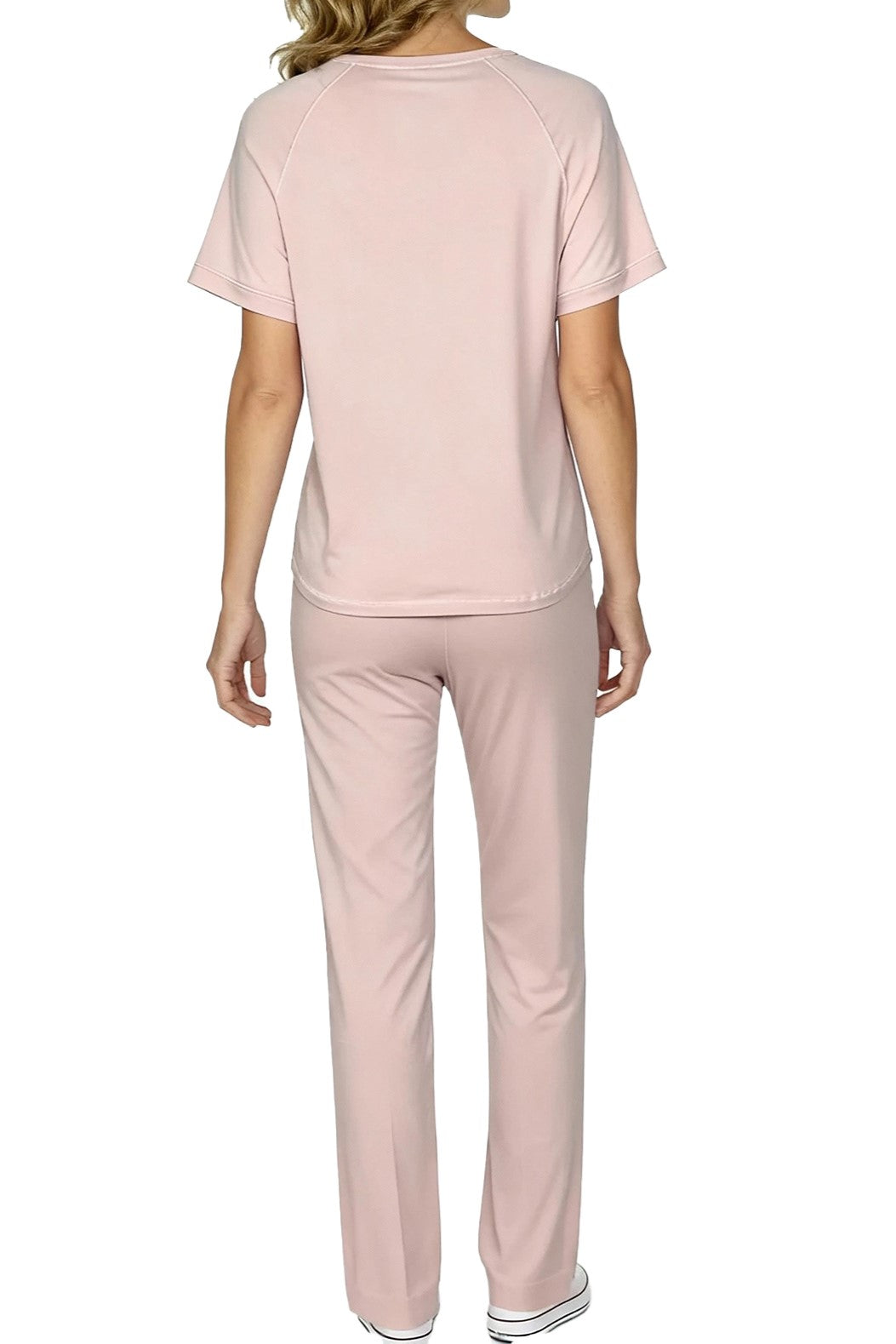 Back view of person wearing light pink short sleeve top and matching pants outfit with white sneakers