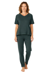 Woman wearing dark green Pima cotton loungewear set with short sleeves and pants