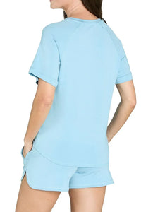 Woman wearing light blue Pima cotton loungewear sleepwear shorts and tee set, back view