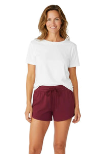 Woman wearing a white Pima cotton t-shirt and burgundy loungewear shorts