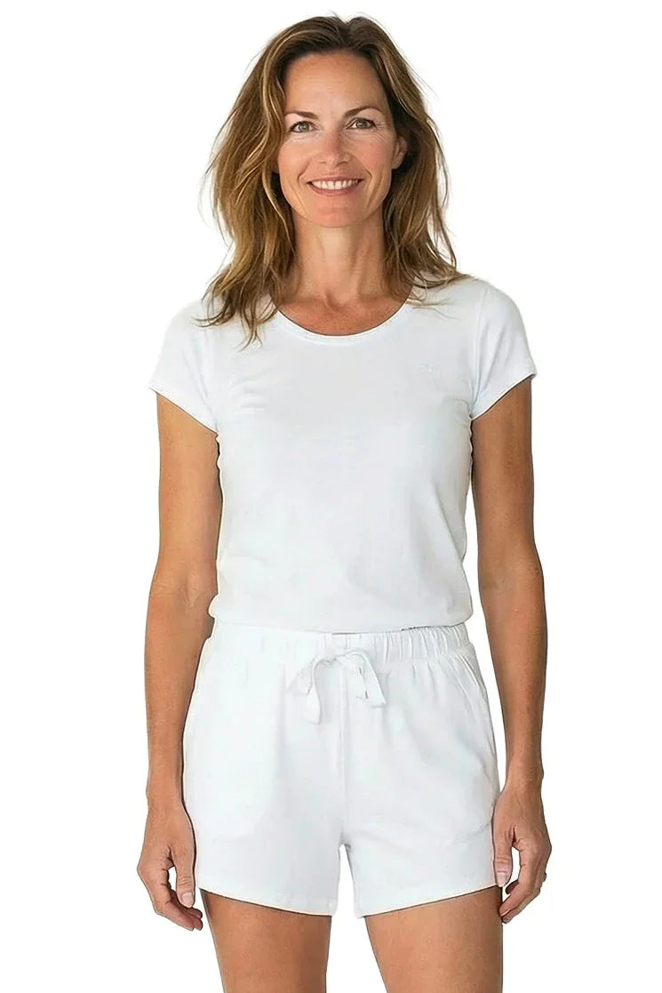 Woman wearing white Pima cotton loungewear set with short sleeves and drawstring shorts
