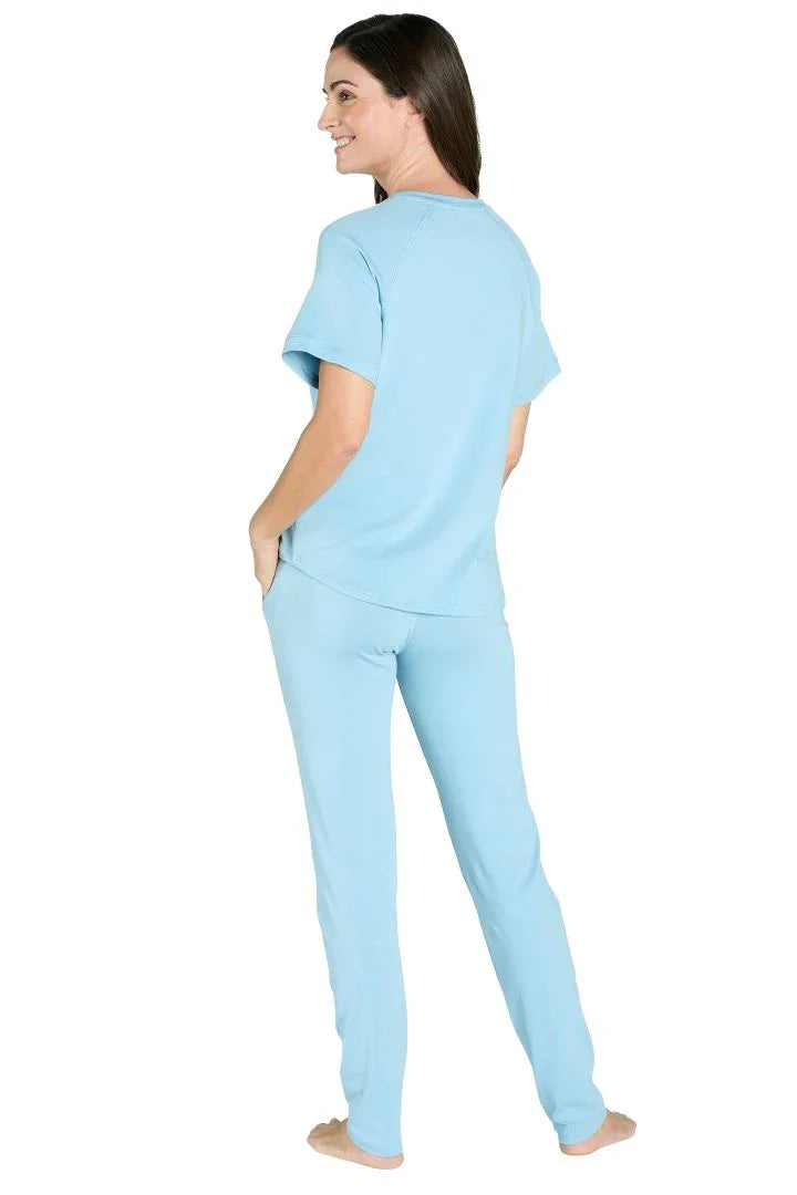 Woman wearing light blue Pima cotton loungewear tee and pants, standing barefoot