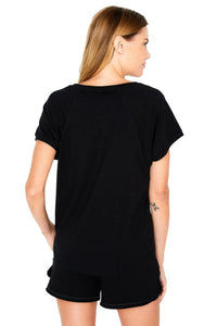 Back view of woman wearing black Pima cotton sleepwear tee and shorts set