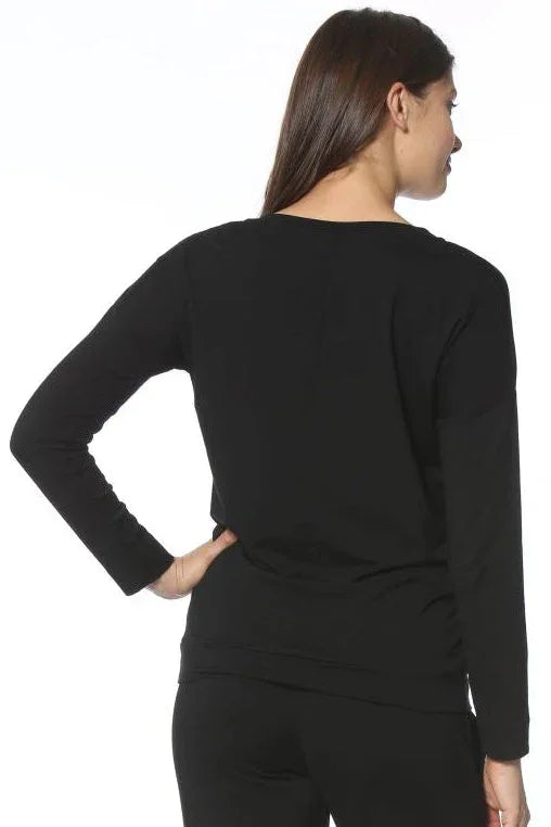Woman wearing black long sleeve Pima cotton loungewear top and pants, back view