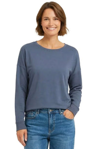 Woman wearing a steel blue long sleeve Pima cotton loungewear top with blue jeans