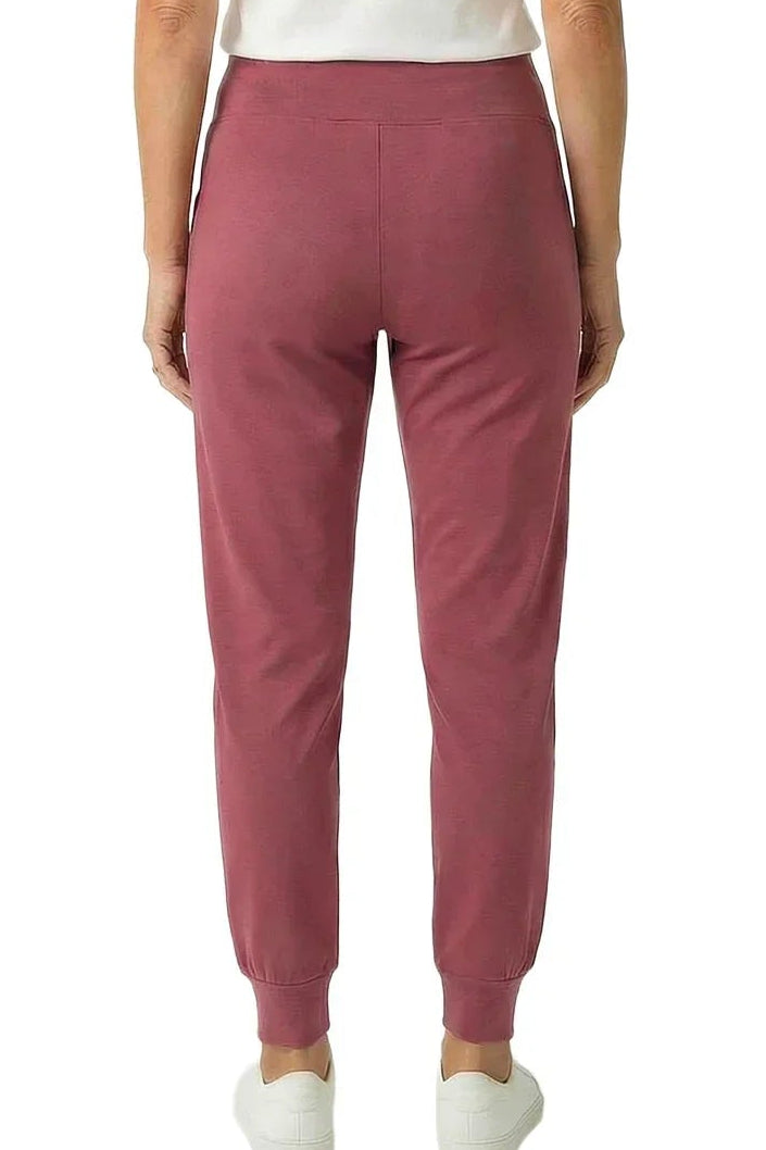 Woman wearing rose pink lounge joggers and white short sleeve tee, back view