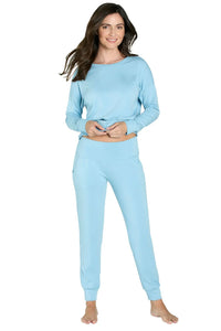 Woman wearing sky blue long sleeve Pima cotton loungewear sleepwear set, barefoot