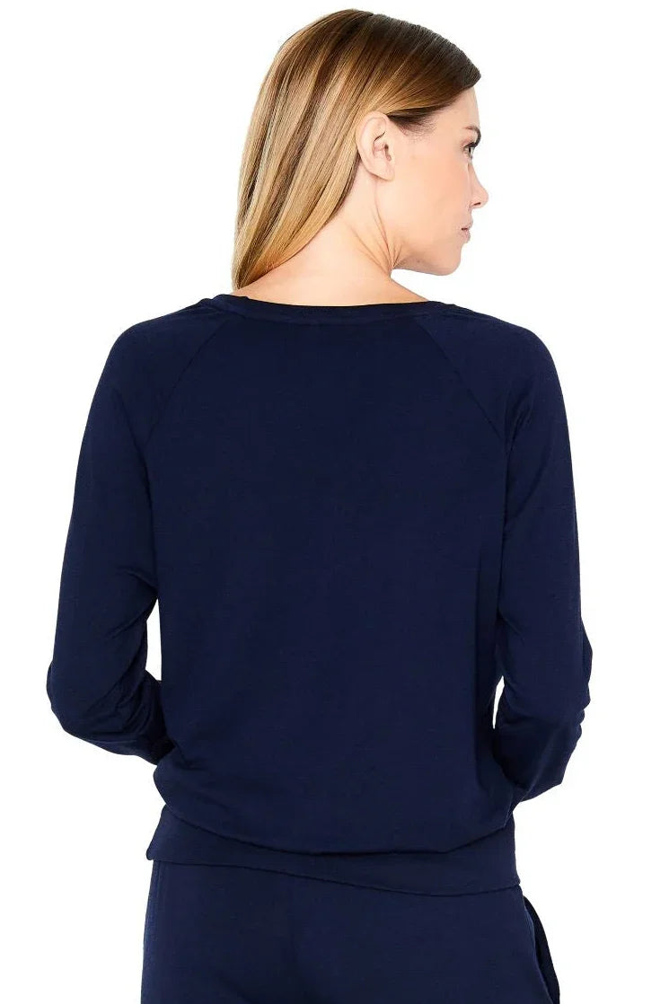 Back view of woman wearing midnight blue long sleeve Pima cotton loungewear top