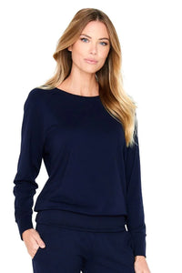 Woman wearing midnight blue long sleeve Pima cotton loungewear top and pants