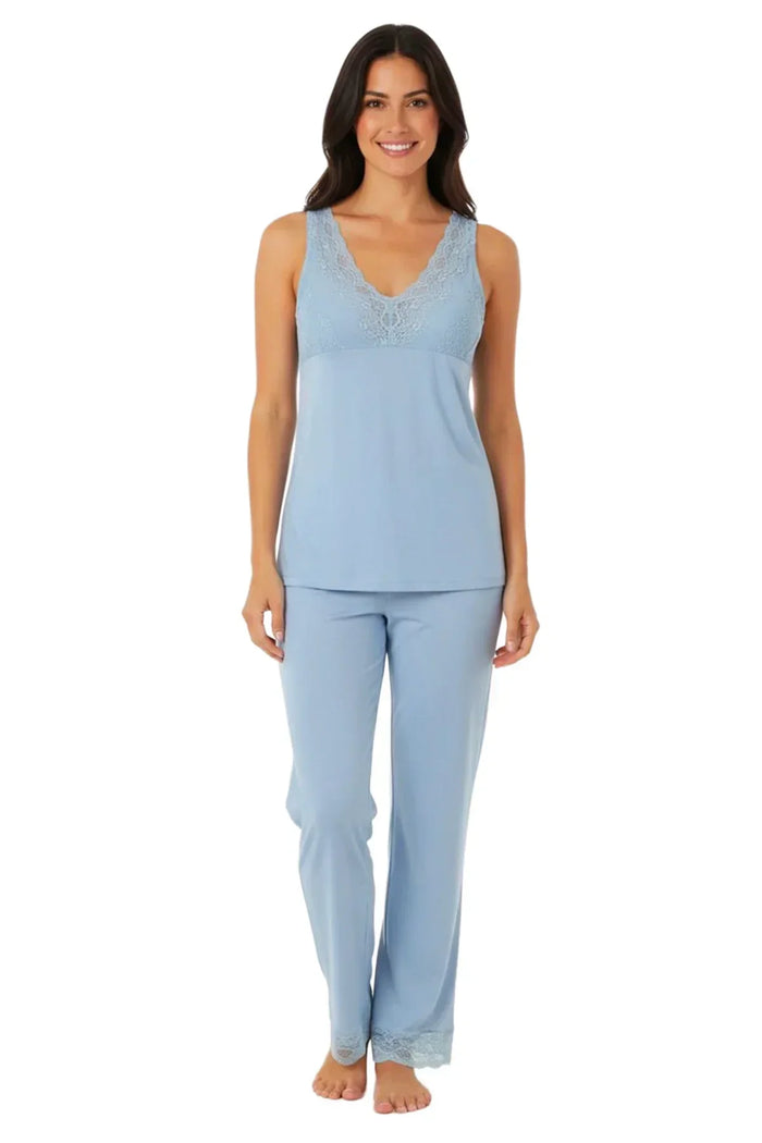 Woman wearing light blue sleeveless lace trim loungewear pajamas set, standing barefoot