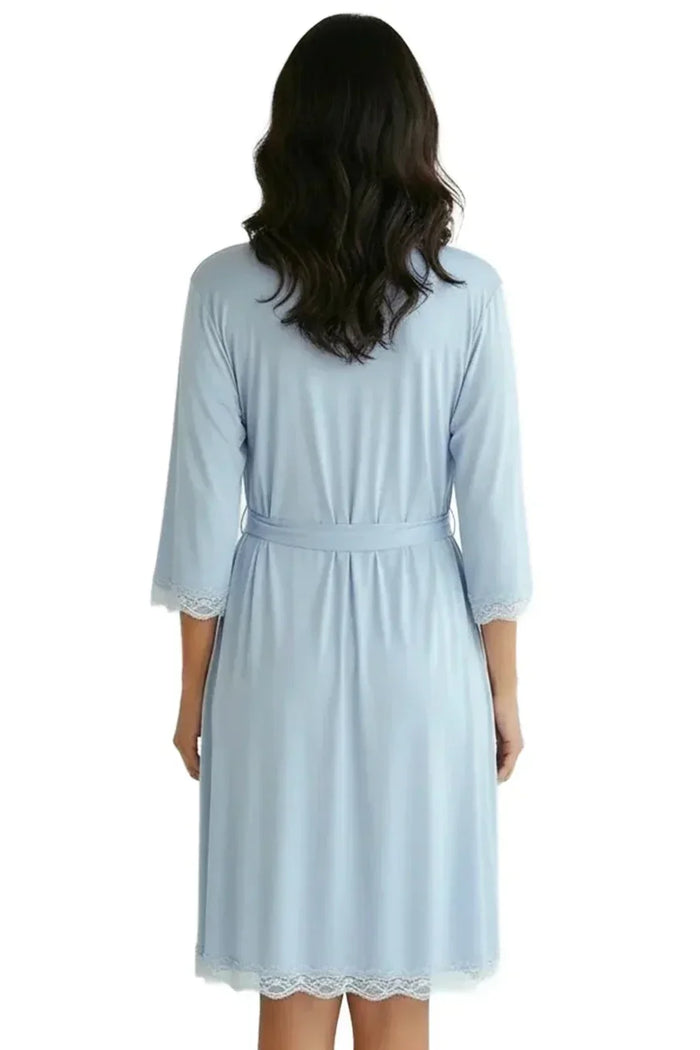 Woman wearing light blue loungewear robe with lace trim, viewed from the back