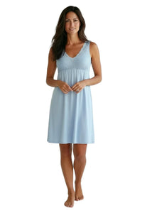 Woman wearing light blue sleeveless lace-trimmed nightgown, relaxed loungewear style