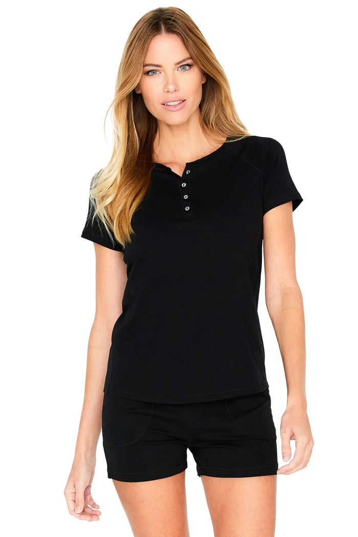 Woman wearing black short sleeve henley lounge top and matching shorts set