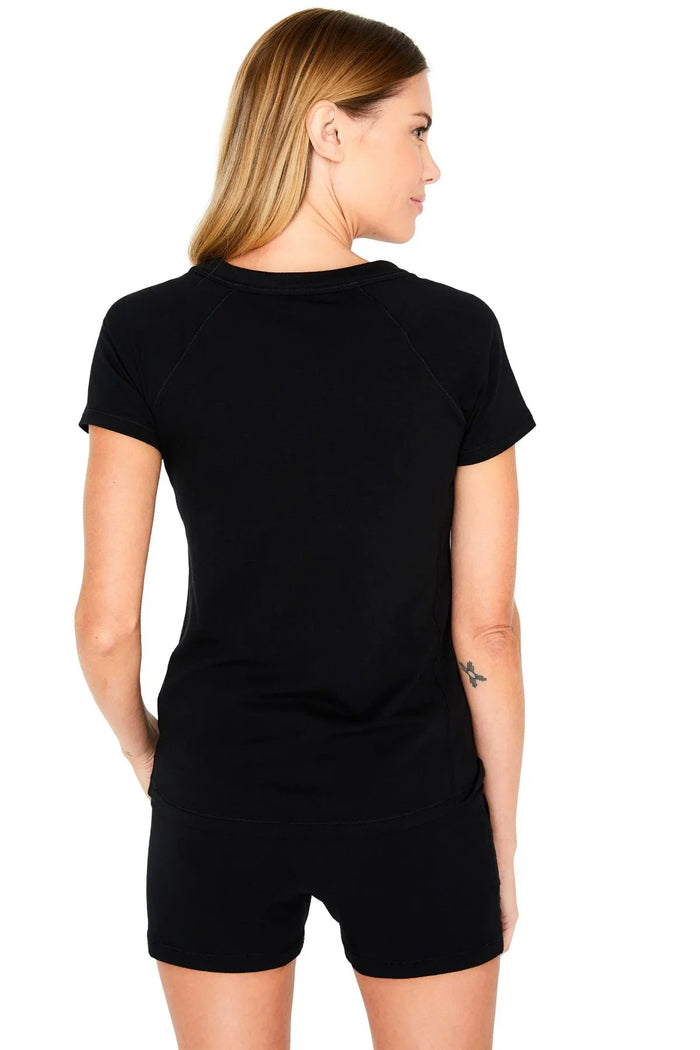 Woman wearing black Pima cotton loungewear t-shirt and shorts, back view