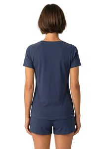 Woman wearing short sleeve steel blue loungewear sleepwear tee and shorts, back view
