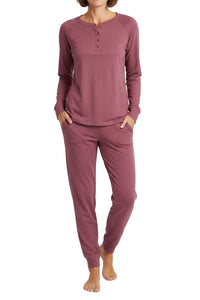 Woman wearing a long sleeve  rosewood loungewear set on a white background