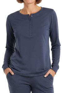 Woman wearing a henley long-sleeve steel blue color shirt on a white background