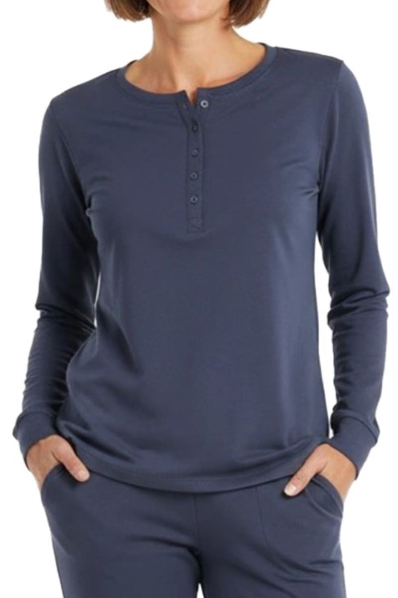 Woman wearing a henley long-sleeve steel blue color shirt on a white background