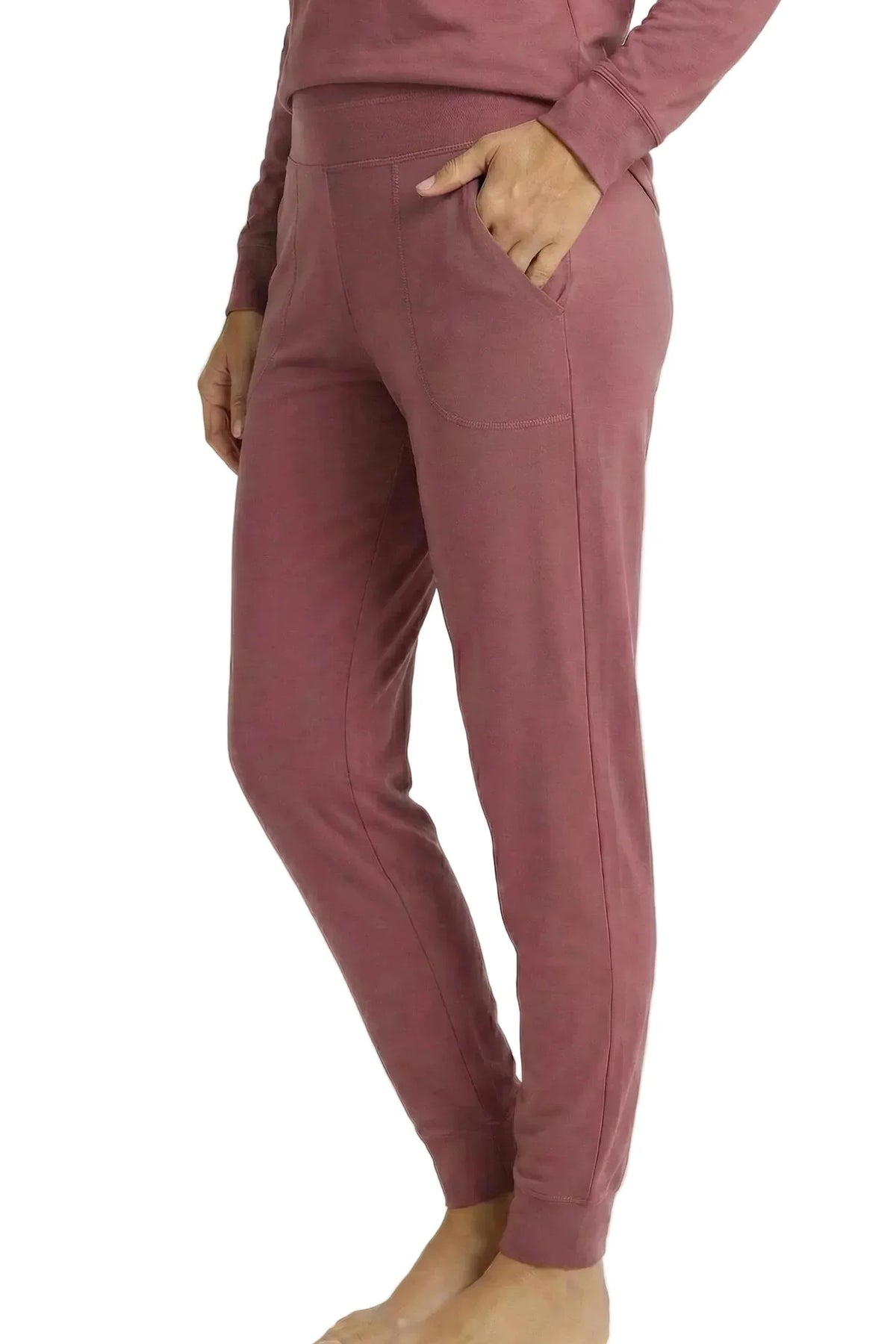 Woman wearing rosewood pink Pima cotton lounge joggers with side pockets